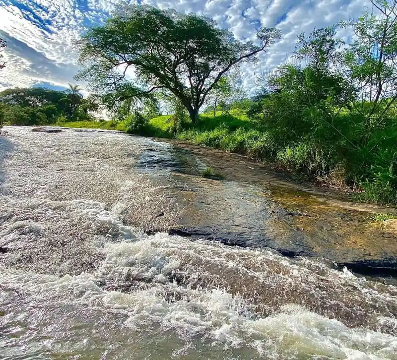 Cachoeira do Escorrega em Analândia (SP), com a pedra lisa do escorregador natural e água corrente entre árvores